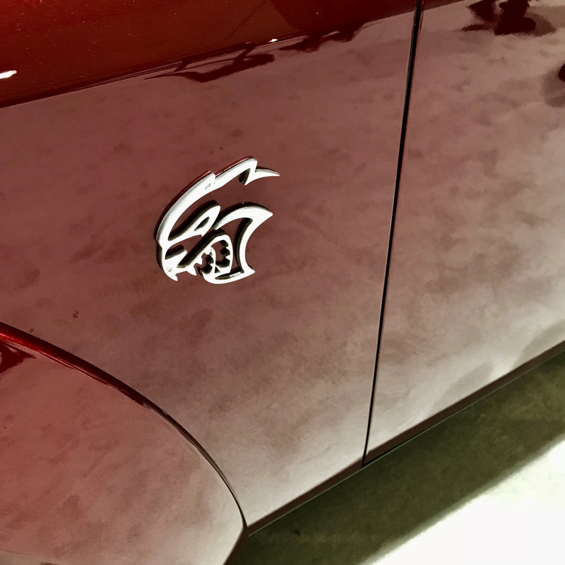 HELLCAT widebody. Locked up tight to keep the riff-raff out. Saw some disappointed children and a remarkably stereotypical hick who (not joking) excitedly but excruciatingly audibly sounded out half the options list on the window sticker before trying the door and then leaving the area, visibly dejected.